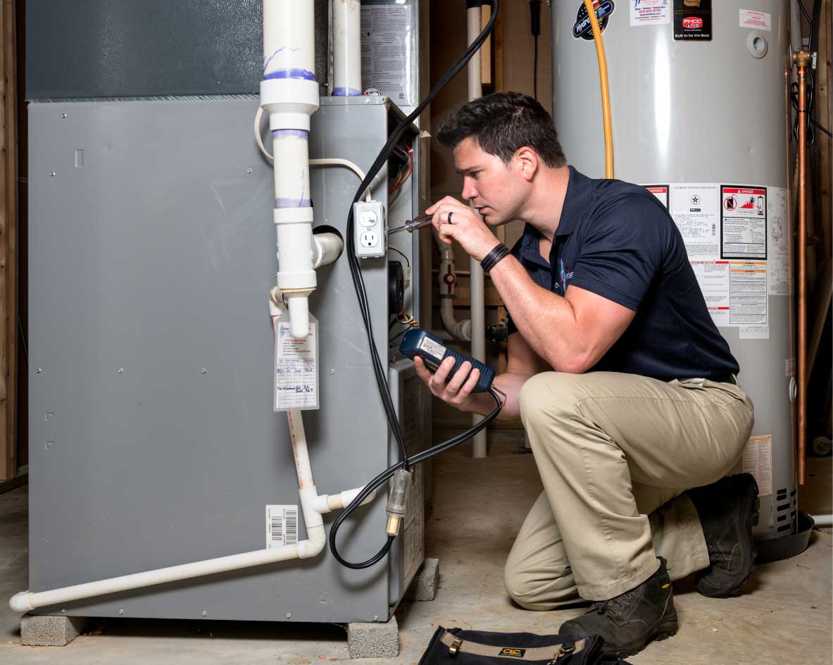 HVAC technician performing a furnace tune-up in Pueblo