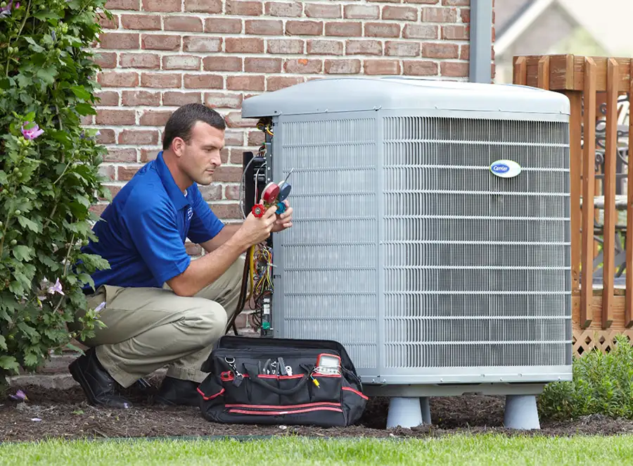 HVAC technician inspecting an outdoor air conditioning unit in Pueblo